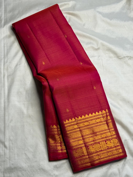 Red-Pink Vairaoosi Kanchipuram silk with small spaced gold zari buttas.