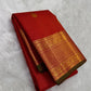 Folded red oosi kattam Kanchipuram silk saree with zari woven border and green edge, available in the USA