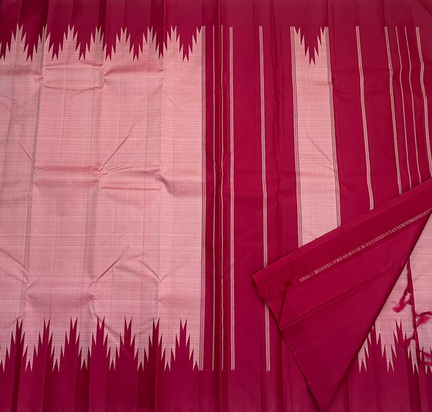 Stacked folds of scarlet red Kanchipuram silk saree with pink thazampoo reku pattern