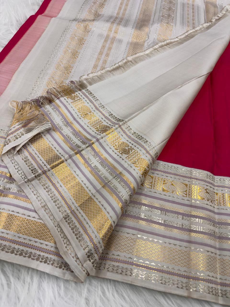 Crimson pure silk Kanchipuram Varisaipet weave, body close-up showing gold zari buttas