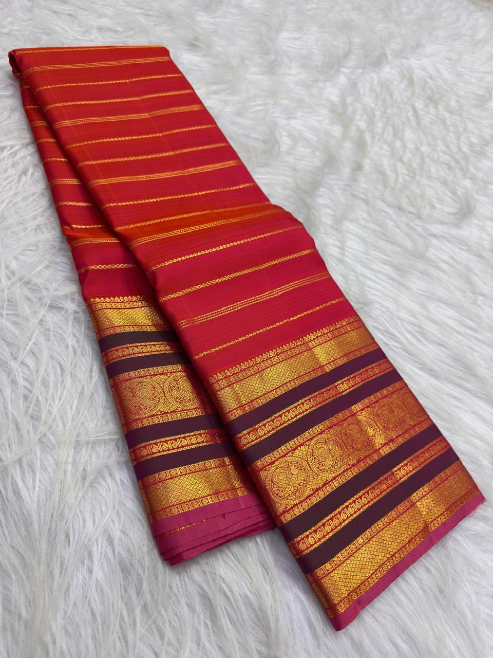 Vermilion red Pure Silk Kanchipuram Varisaipet saree with twisted zari bands.