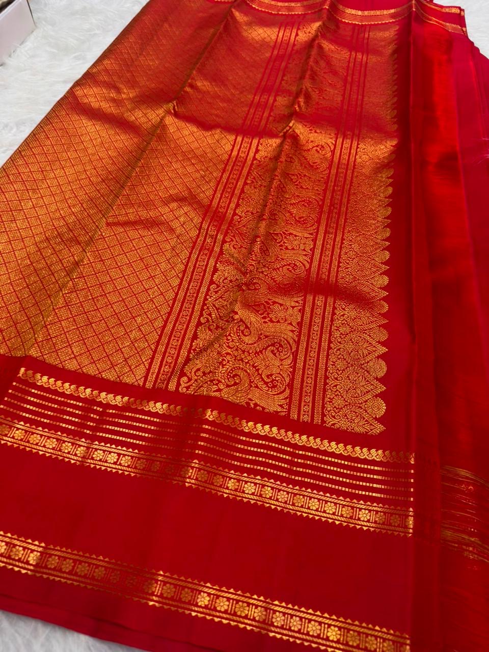 Tonal red Rettapet border with multiple parallel classic-gold zari registers and floral rosette detailing.