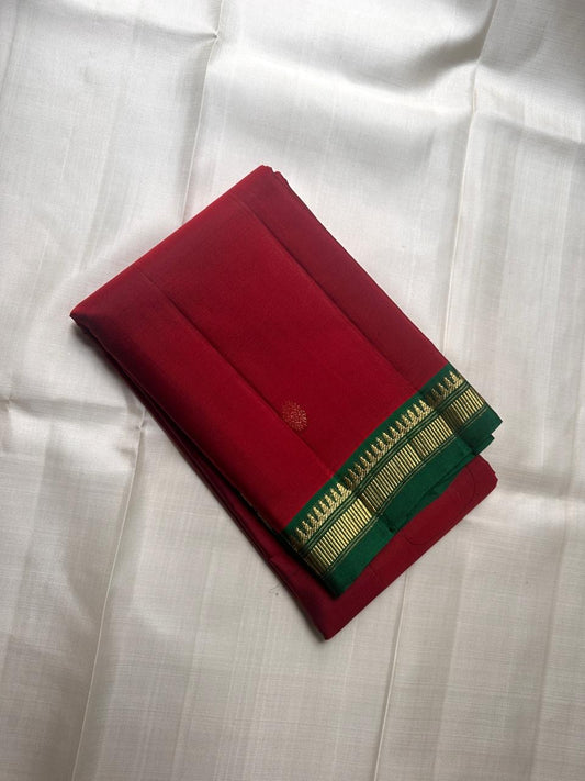 Green and red pure Kanchipuram silk saree spread open showing antique gold zari border and contrast color layout