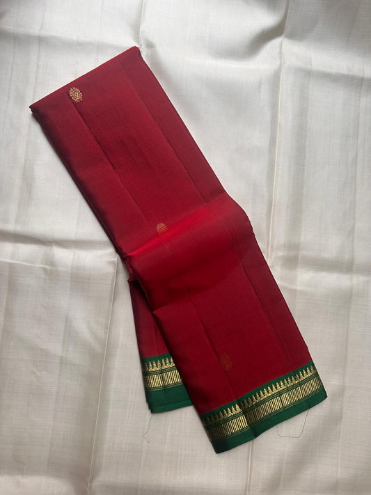 Green pure Kanchipuram silk saree body laid flat with vertical antique gold zari lines across the surface, available in the USA