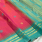 Shot colour tomato red pink Kancheepuram saree body close-up showing Mayil Chakram peacock medallion buttas in coloured silk thread