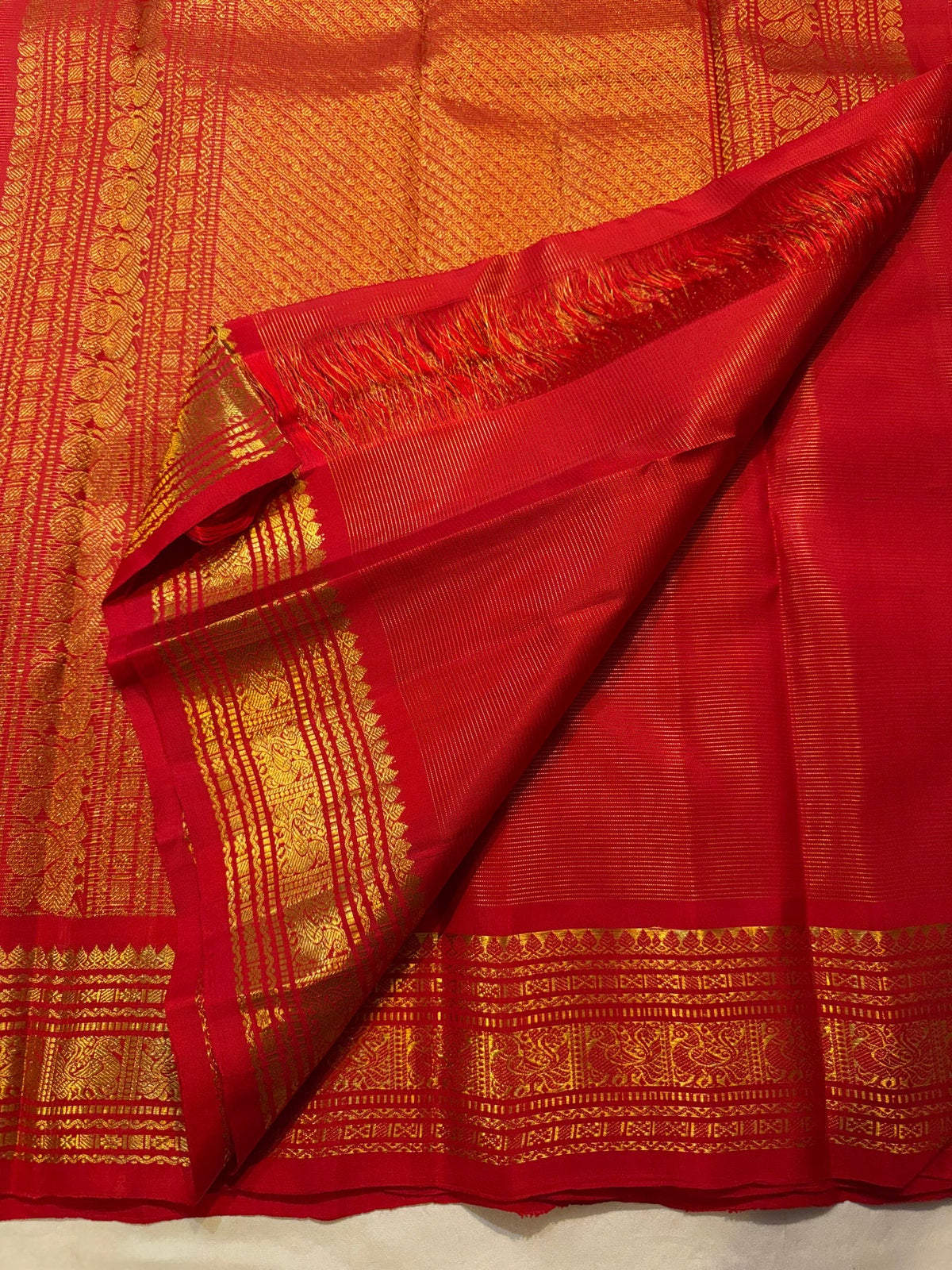 Kumkumam red Kanchipuram silk saree draped, pallu detail