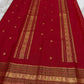 Pillar red Kanjivaram saree folded flat displaying varisaipet border with peacock zari motifs Idam Living