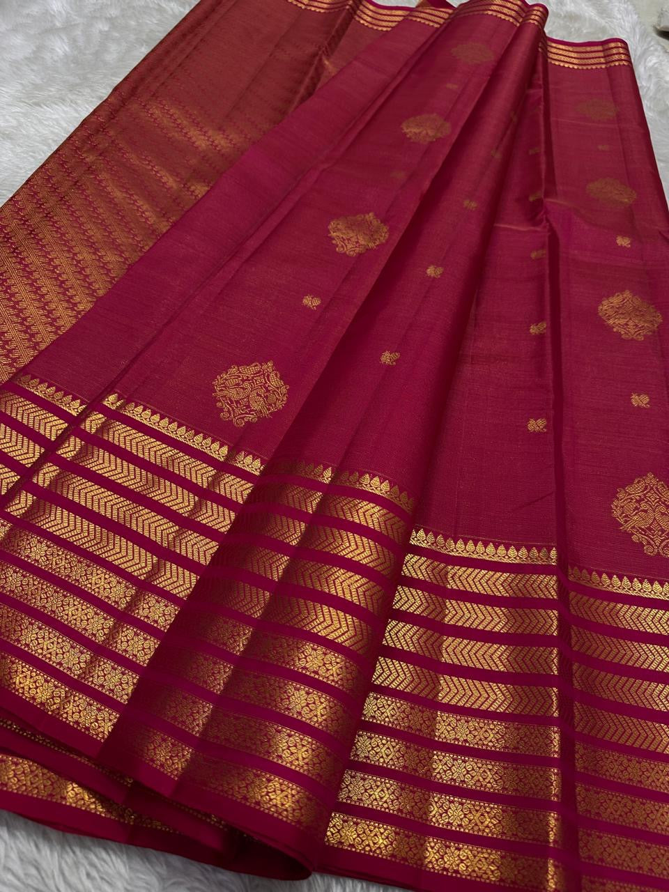 Gold zari bands and medallions on Rani Pink pure silk Kanchipuram saree