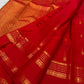 Handwoven Rettapet border showing repeated floral rosettes, fine dotted bands and classic-gold geometric registers.
