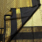 Close-up of the gold zari on the sage green Rettapet Kanjivaram saree