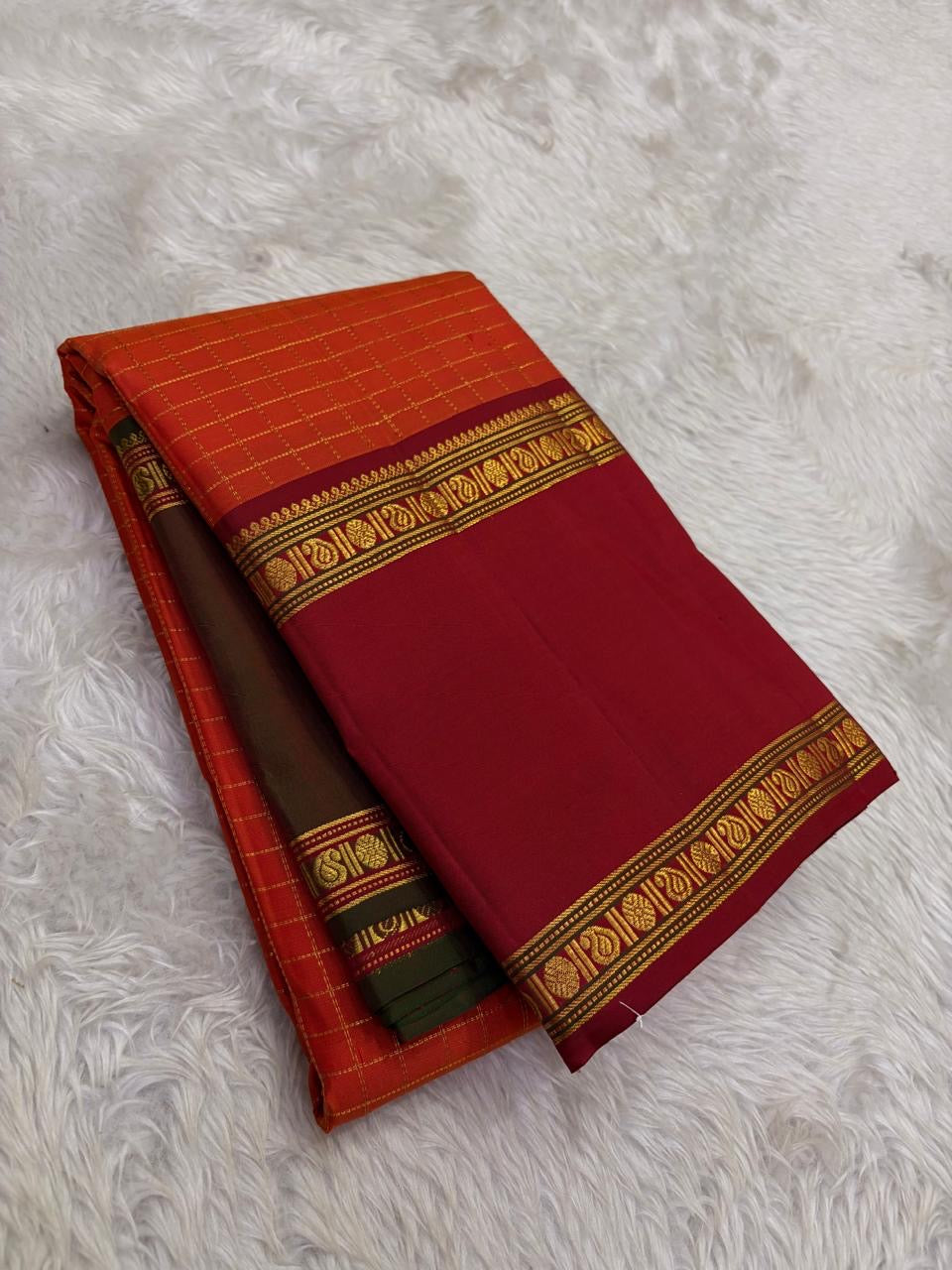 Hand woven Kanchipuram silk saree with peacock teal body and zari motifs