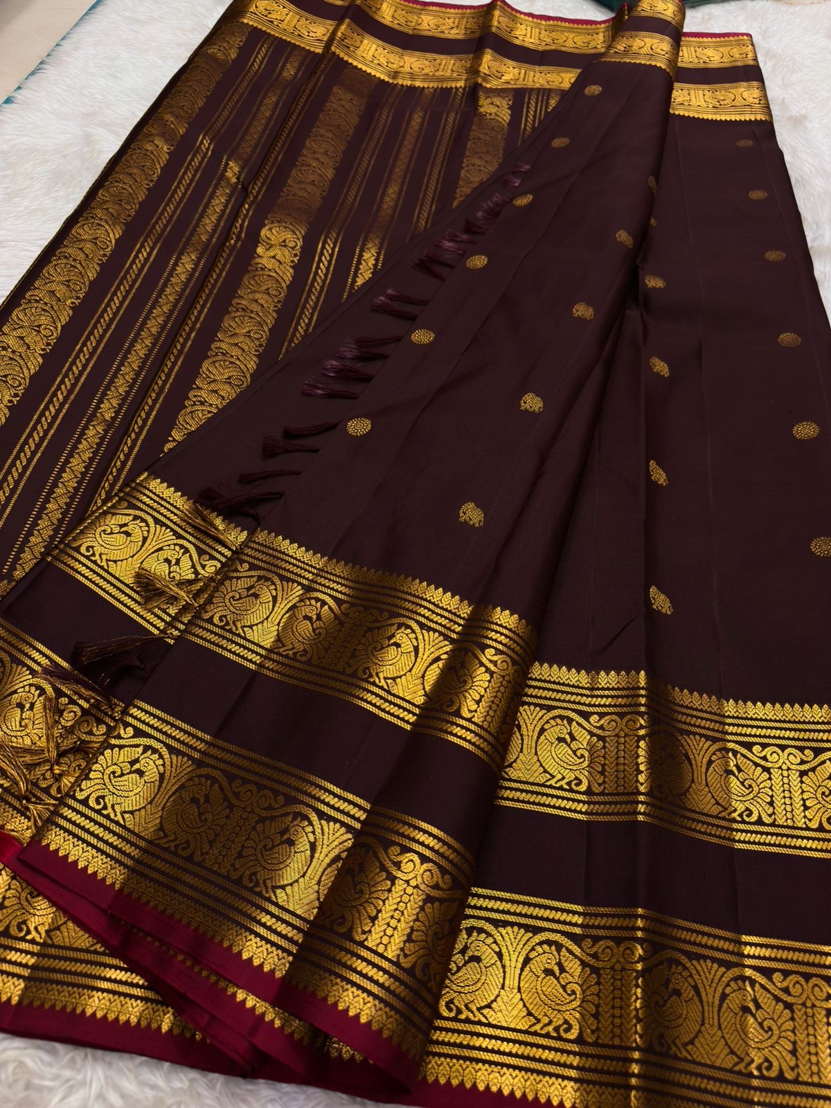 Deep wine plum handwoven pure silk Kanjipuram saree with Rettapet weave Pavun coin butta and ornate antique gold zari border overview