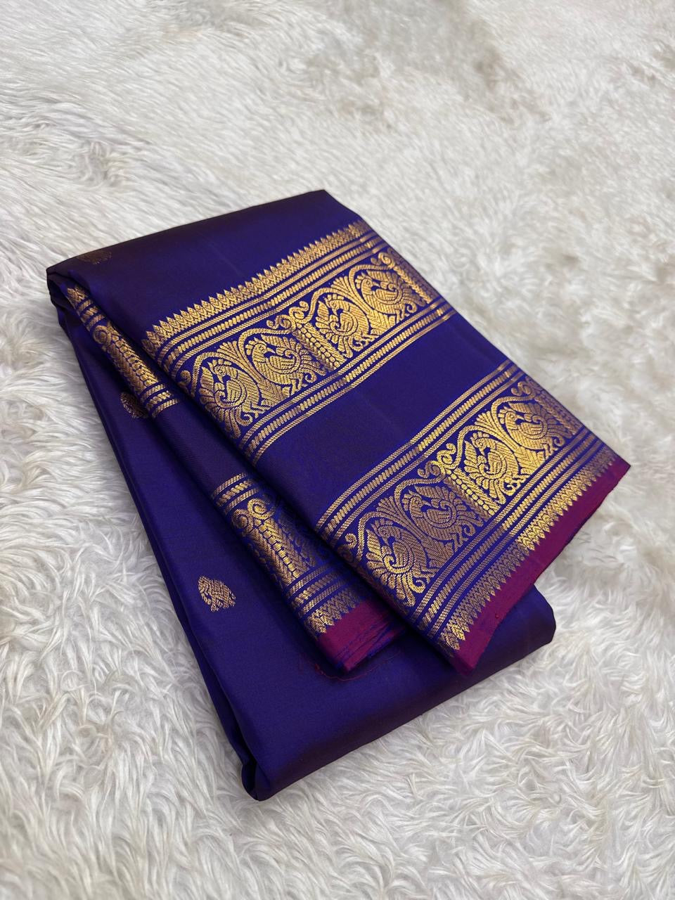 Magenta Korvai border of navy blue Kanjipuram saree with Annam swan and Mayil peacock dense antique gold zari array