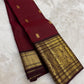 Rich burgundy red Kanchipuram pattu saree with antique gold zari