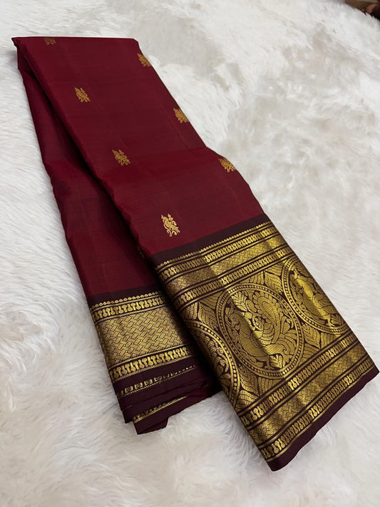 Rich burgundy red Kanchipuram pattu saree with antique gold zari