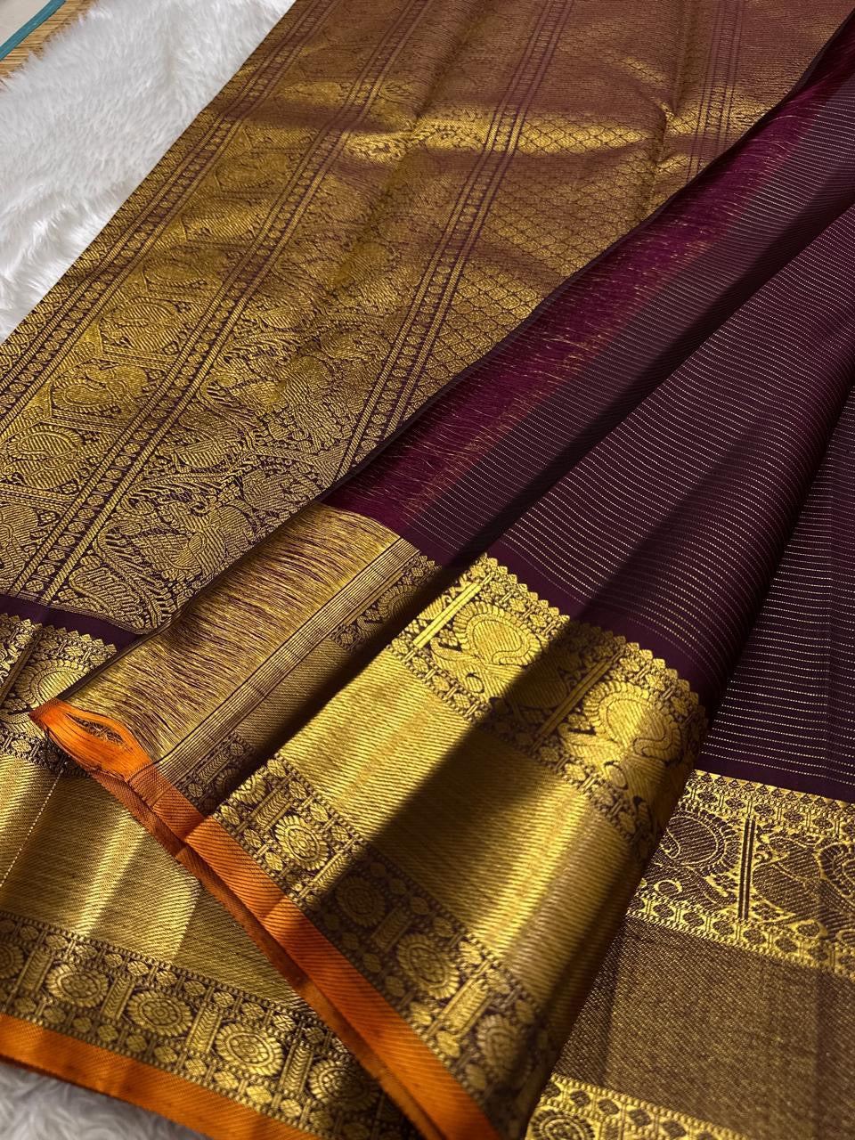 Orange border detail on Rich Burgundy Kanjipuram silk saree