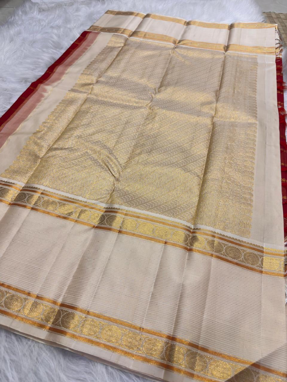Arakku red Rettapet Kanjeevaram silk saree with old-gold zari, folded with running blouse piece