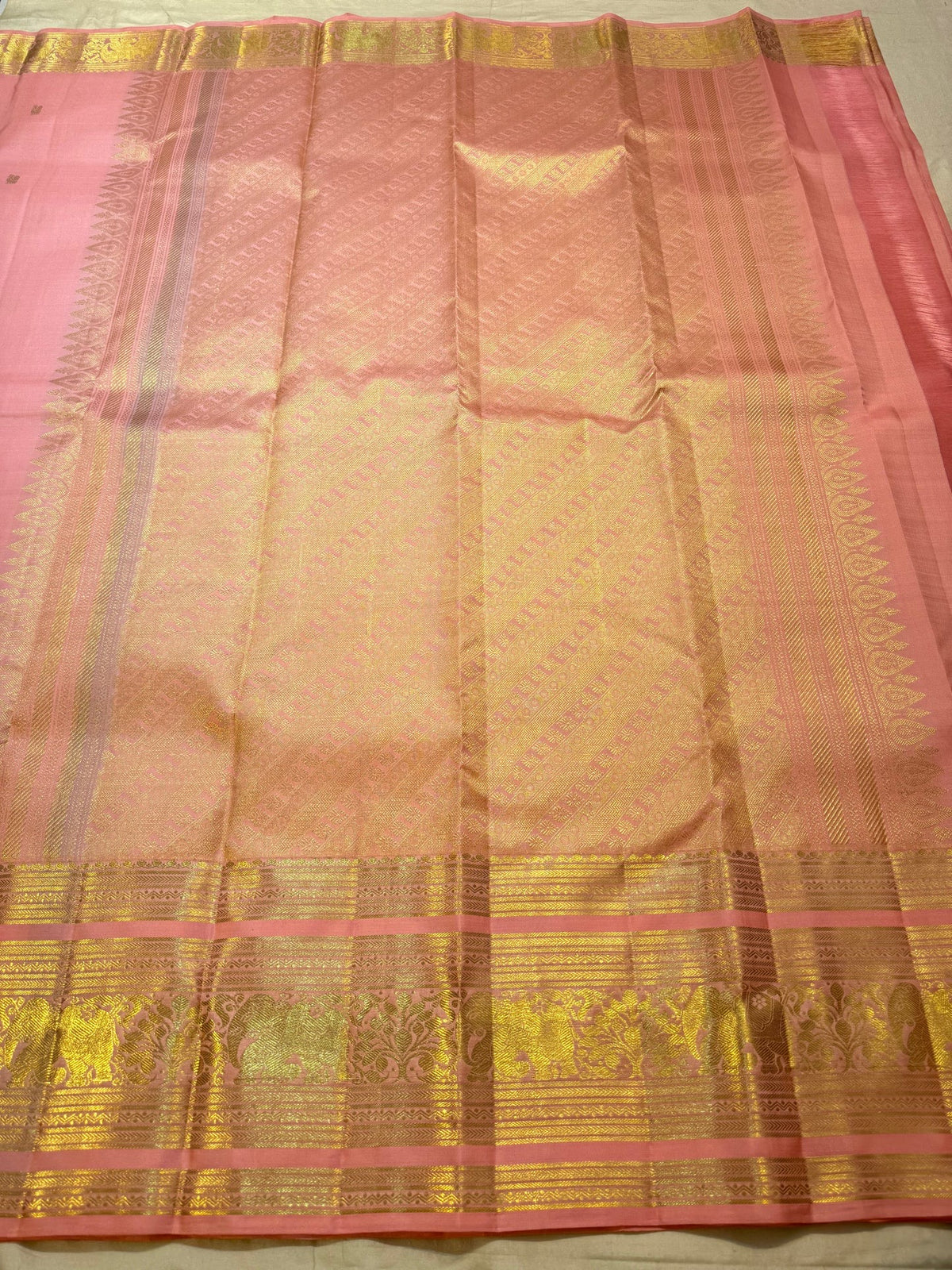 Detail of the elephant (yaanai) motif zari border on the Pattu Roja pink Kanchipuram saree