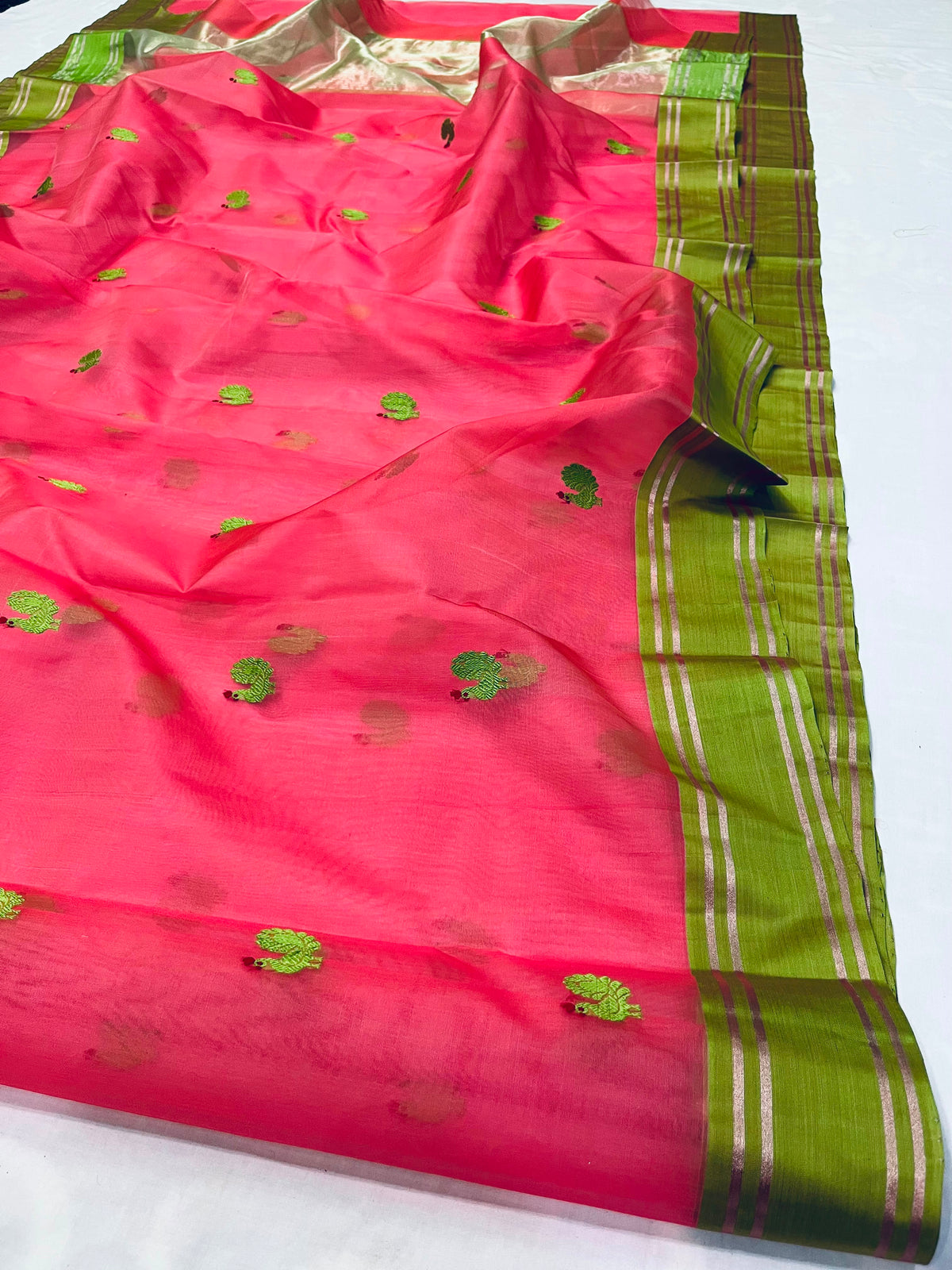 Coral pink Katan Silk Chanderi saree with green rooster motifs and a parrot green border