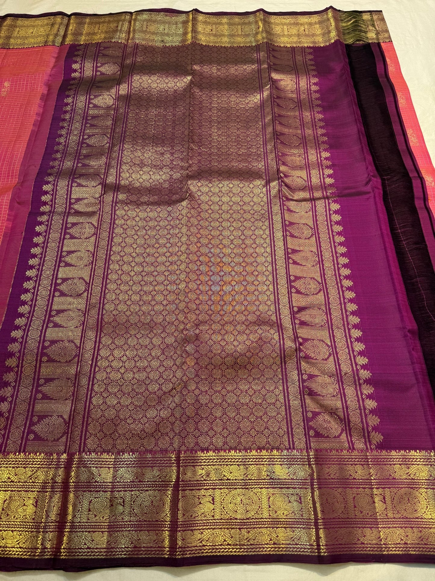 Close-up of chedi butta in gold zari on rose orange double shade Kanchipuram silk saree — Idam Living