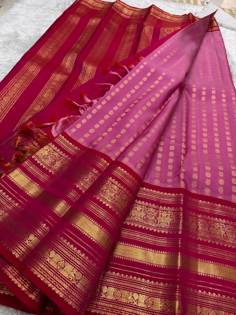Rose pink Kancheepuram silk body close-up showing petite mayil chakram butta motifs