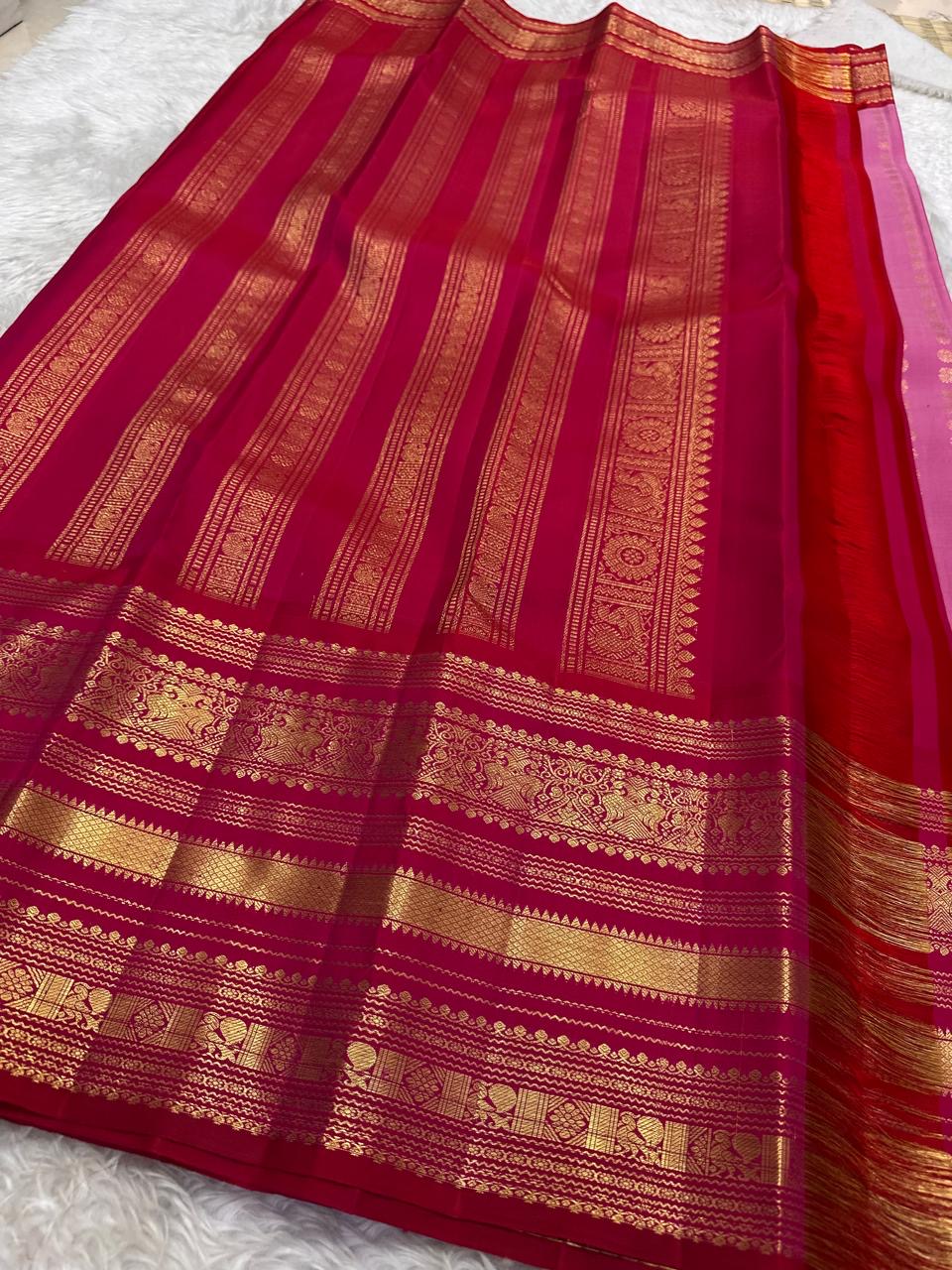 Grand pallu with gold zari peacocks on rose pink Kancheepuram silk saree