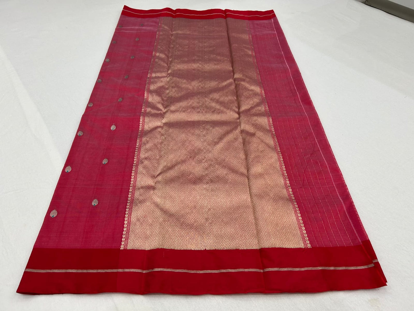 Rose pink Pattu Silk Chanderi saree opened to show red silk border, scattered woven buttas and metallic pallu