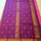 Rose pink Kanchipuram saree with coral-orange and purple contrast border