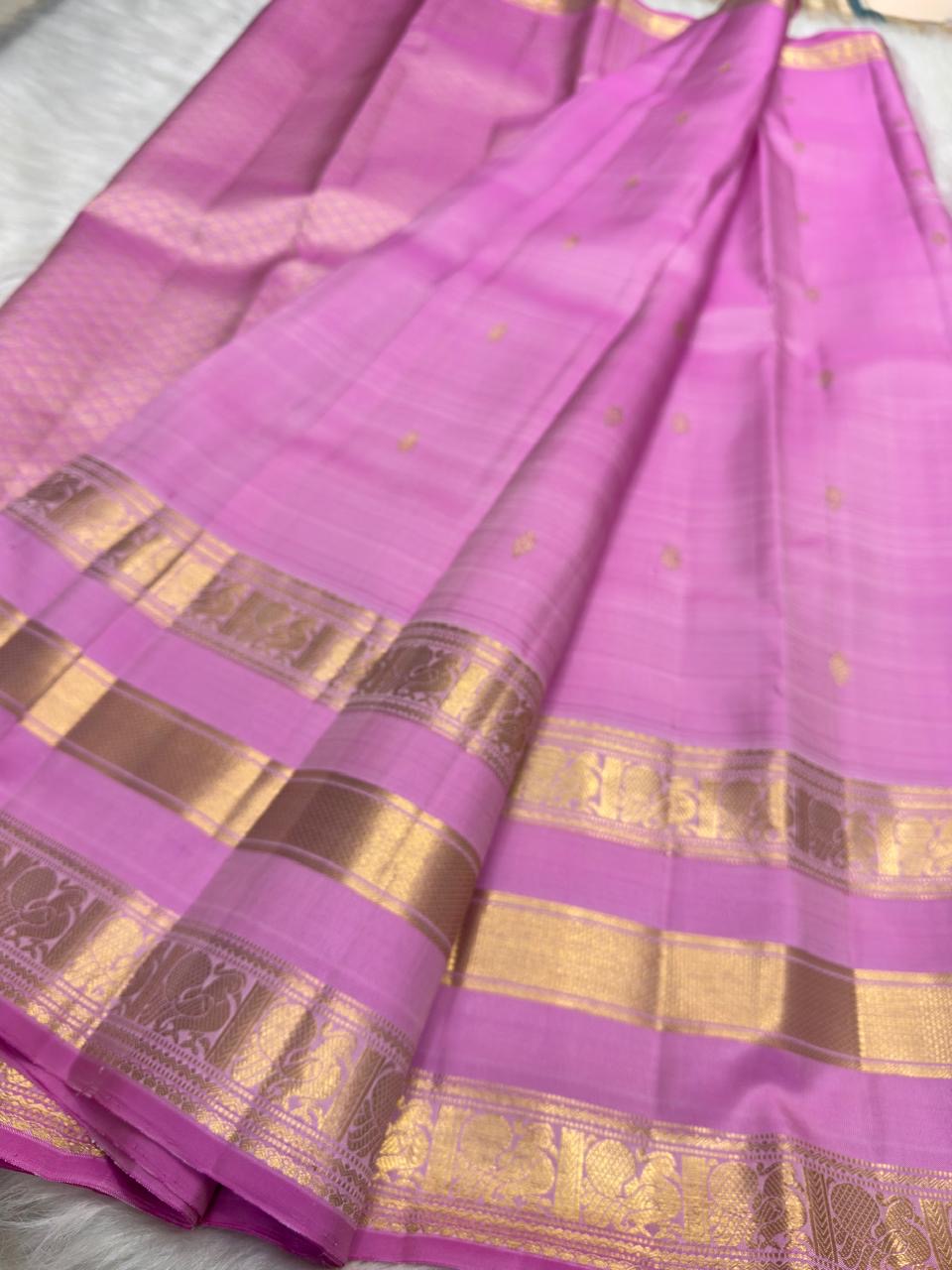 Rose Orchid Pink Kanchipuram silk saree showing layered gold zari border and scattered buttas.