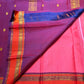 Full view of the rose pink Kanchipuram Butta saree with coral-orange and purple border
