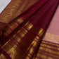 Close-up of antique-gold zari buttas on dusty rose Kanchi Pattu saree body