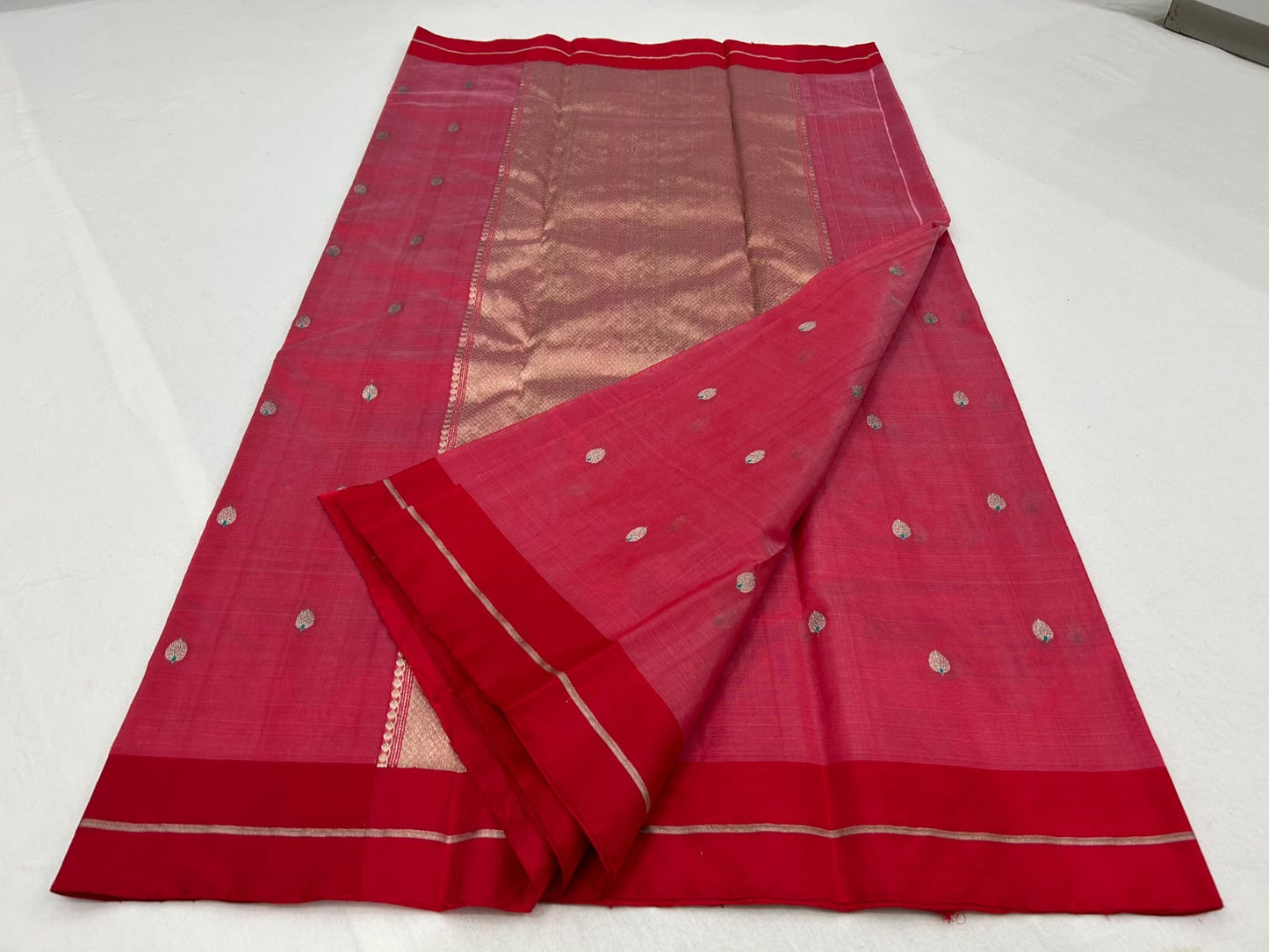Full view of rose pink Chanderi silk saree with rich red border and softly reflective woven pallu