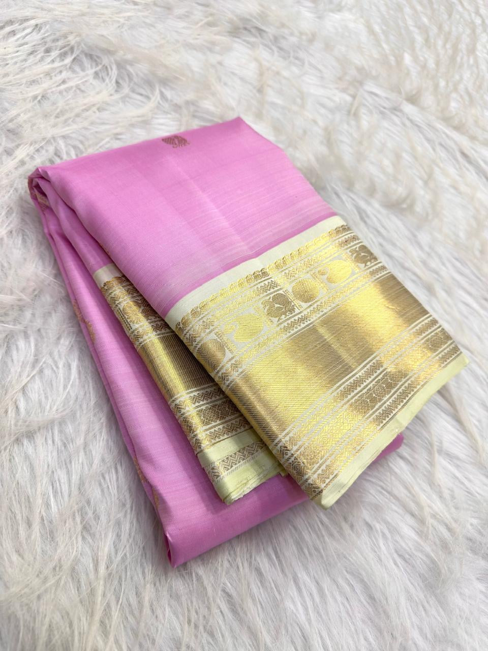 Intricate gold zari pallu detail on Warm Ivory Kanchipuram silk
