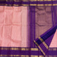 Close-up of the royal purple border with gold zari kasu (coin) motifs on the rose pink Kanchi Pattu saree.