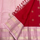 Crimson-red pure silk saree showing circular floral-geometric zari buttas across the body.