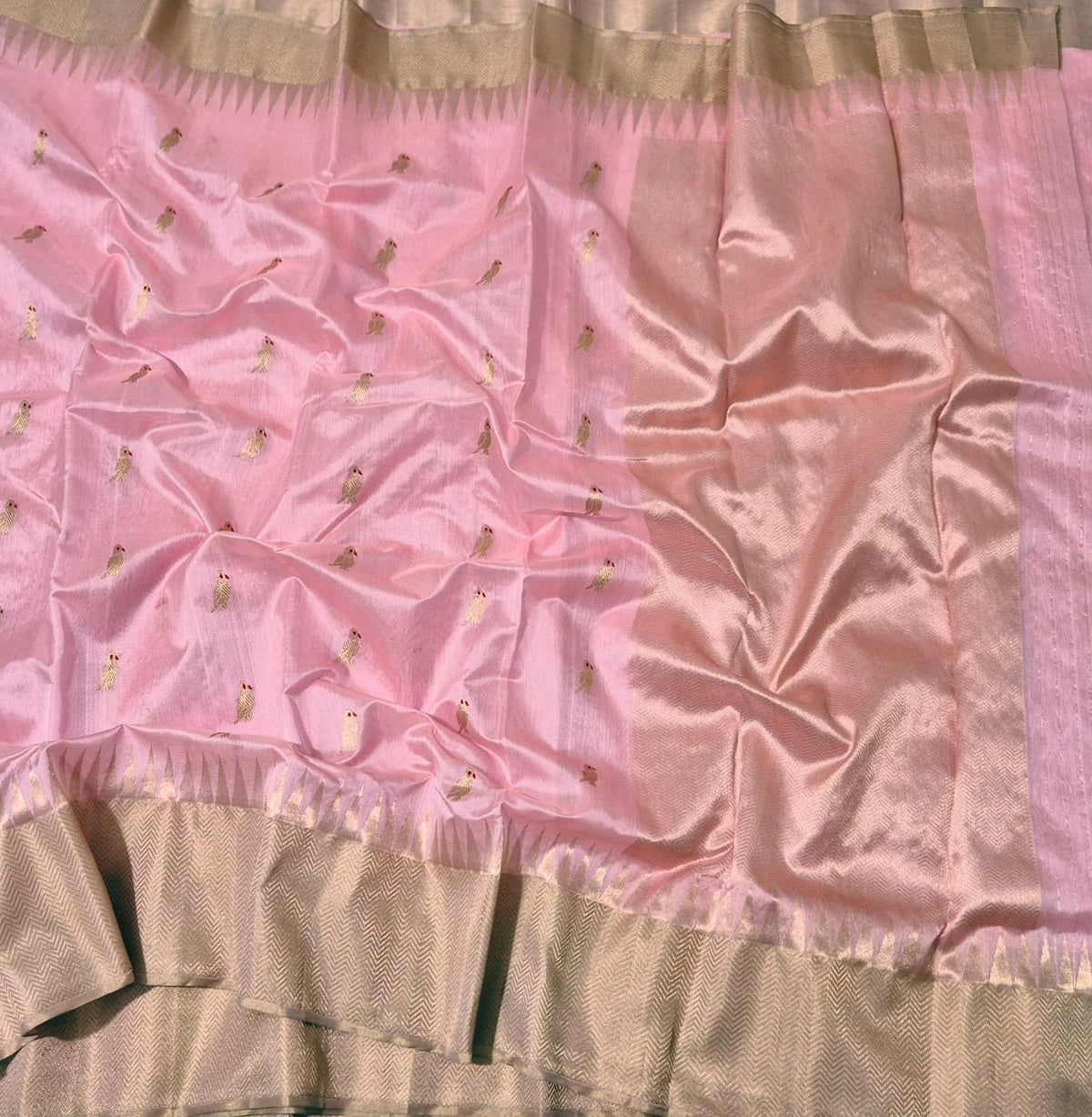 Close-up of golden Minakari parrot buttas on rosewater pink Pattu Silk Chanderi saree
