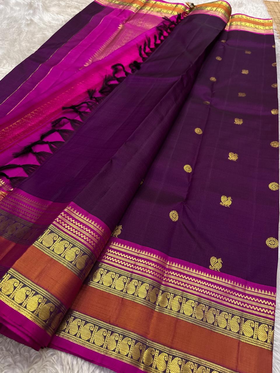 Royal aubergine Kanjipuram silk saree folded, Rettapet border and pallu visible