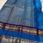 Royal azure blue handwoven pure silk Rettapet saree with silver zari buttas and purple border, styled view