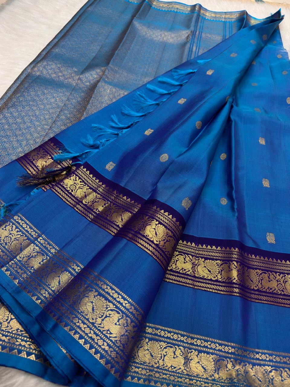Royal azure blue Kanchipuram silk saree with purple border, close-up