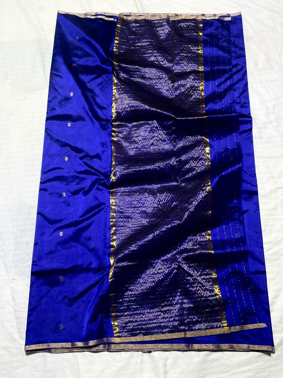 Royal blue Chanderi saree opened to display its finely lined metallic pallu.
