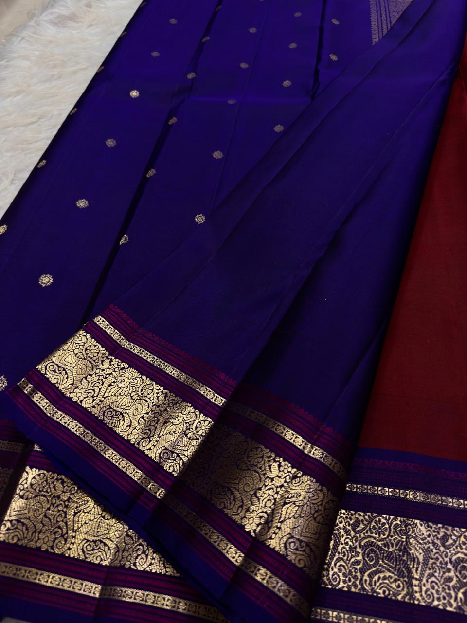Deep cherry red and royal blue Pure Silk Kanchipuram saree with burgundy undertones and gold zari