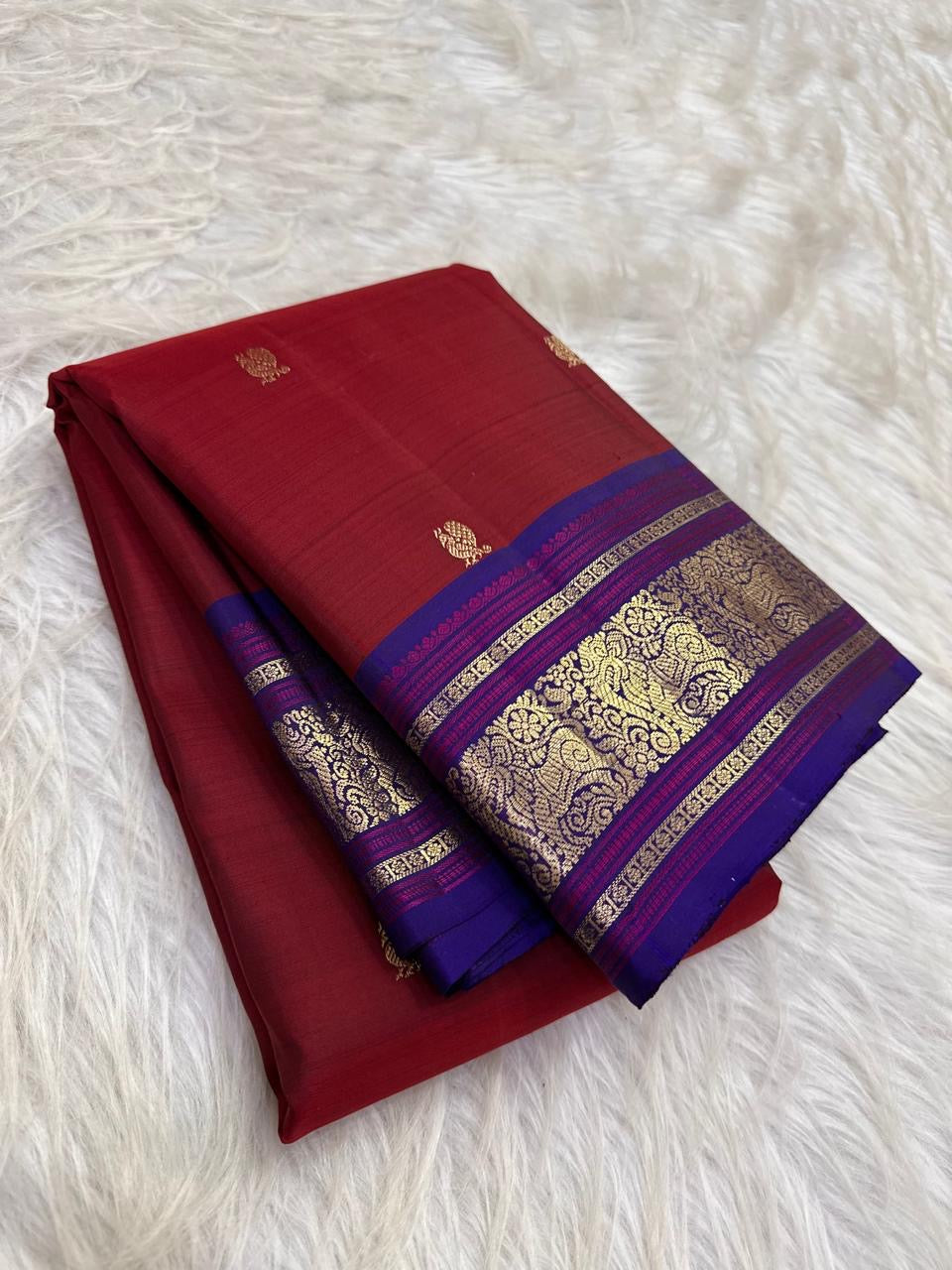 Royal blue contrast border with ornamental zari on cherry red Pure Silk Kanchipuram saree
