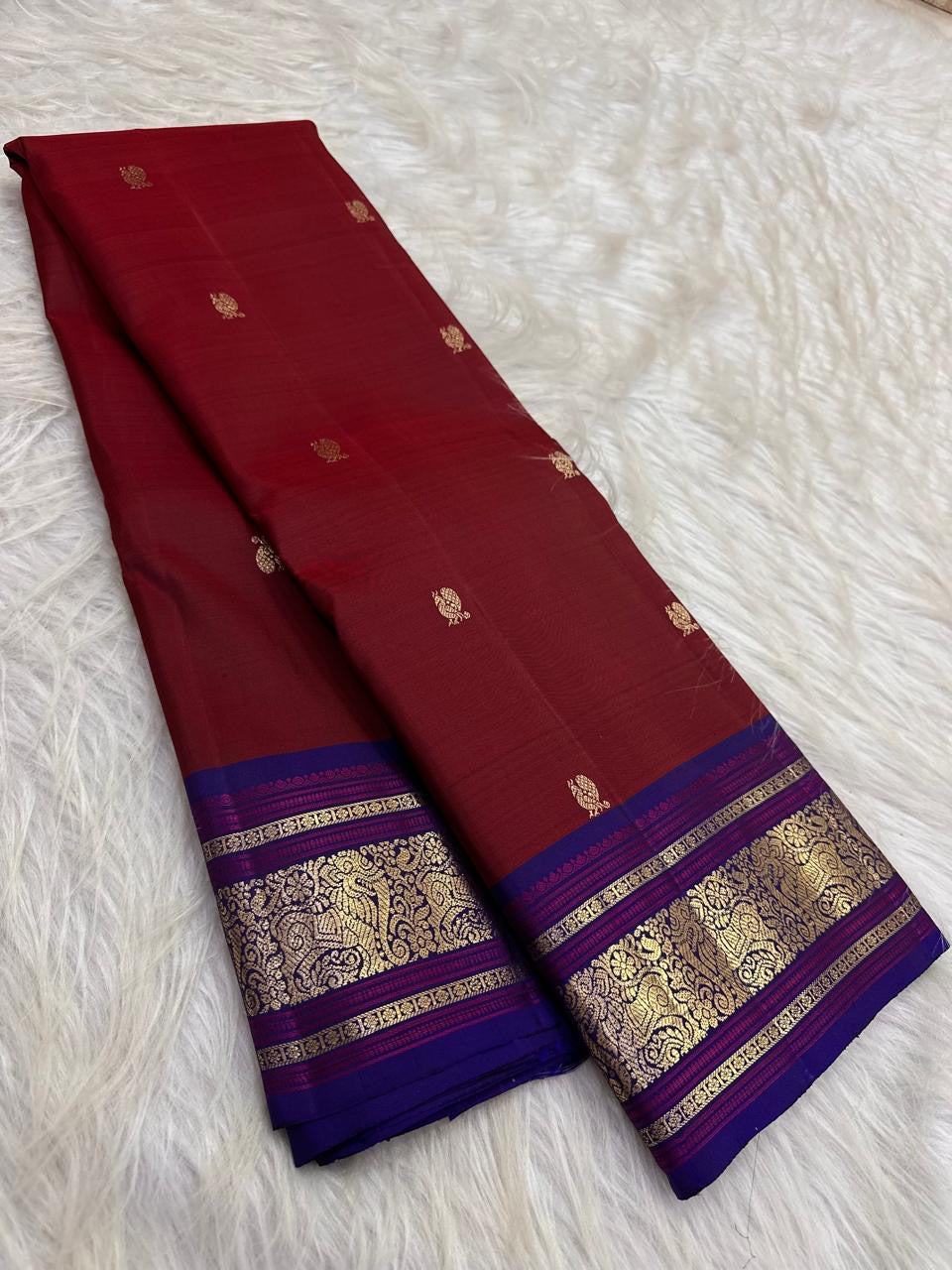 Petite handwoven mayil buttas in gold zari on deep cherry red Kanchipuram silk