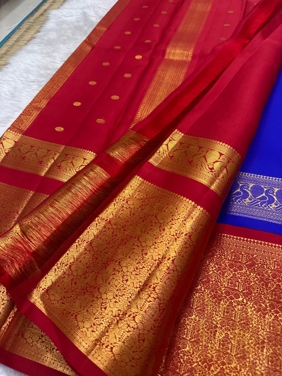 Royal Blue and Arakku Red Korvai Kanchipuram saree with rich gold zari.