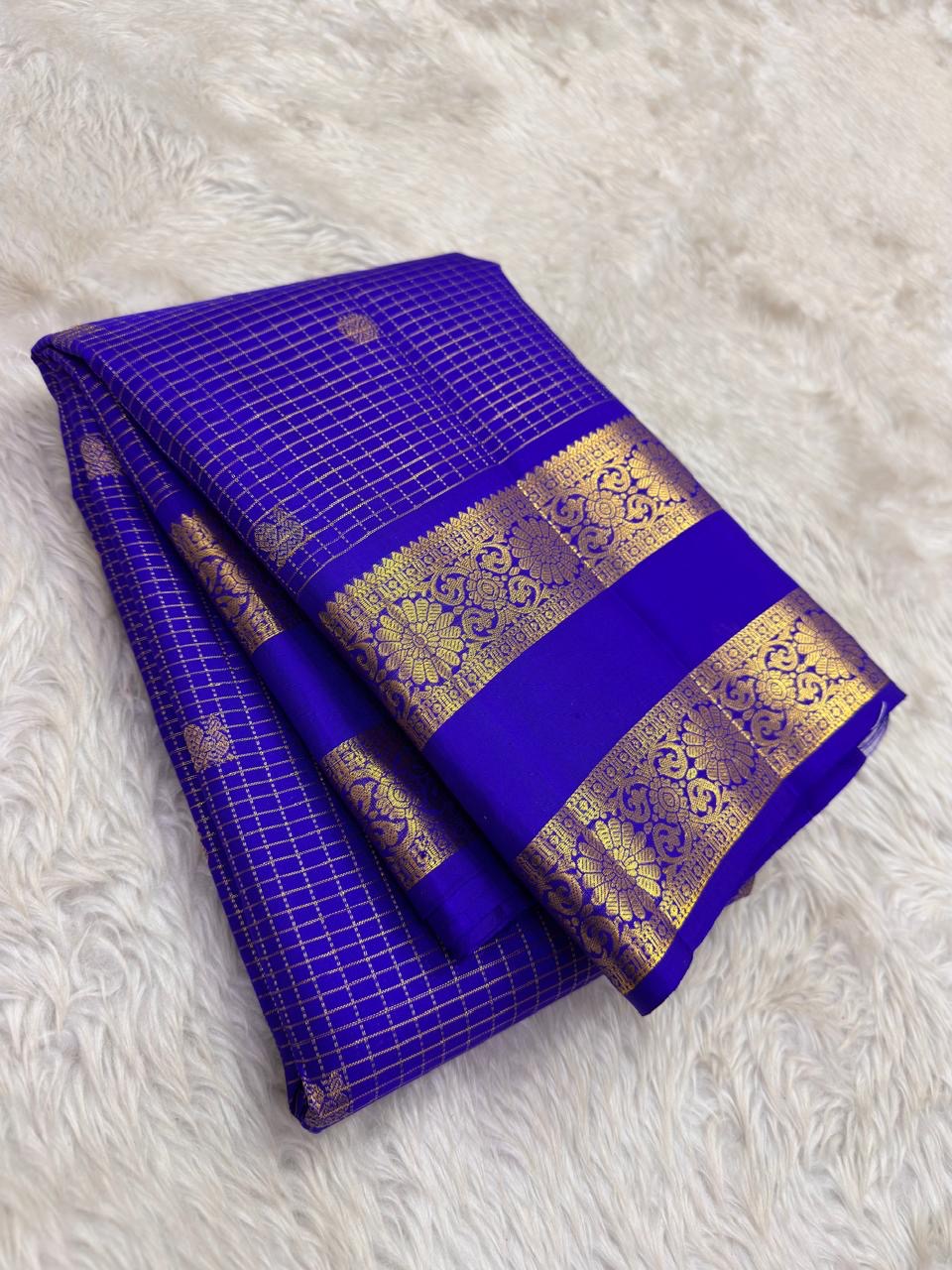 Ornate self-colour border of royal blue Kancheepuram saree with dense Kamalam and Mayil antique gold zari array