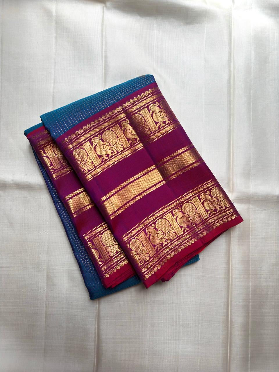 Royal blue handwoven pure silk Kancheepuram saree with magenta Varisaipet border, full front view