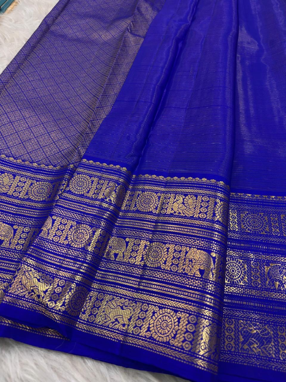 Royal blue Kanchipuram silk saree with detailed ornate bands in antique gold zari
