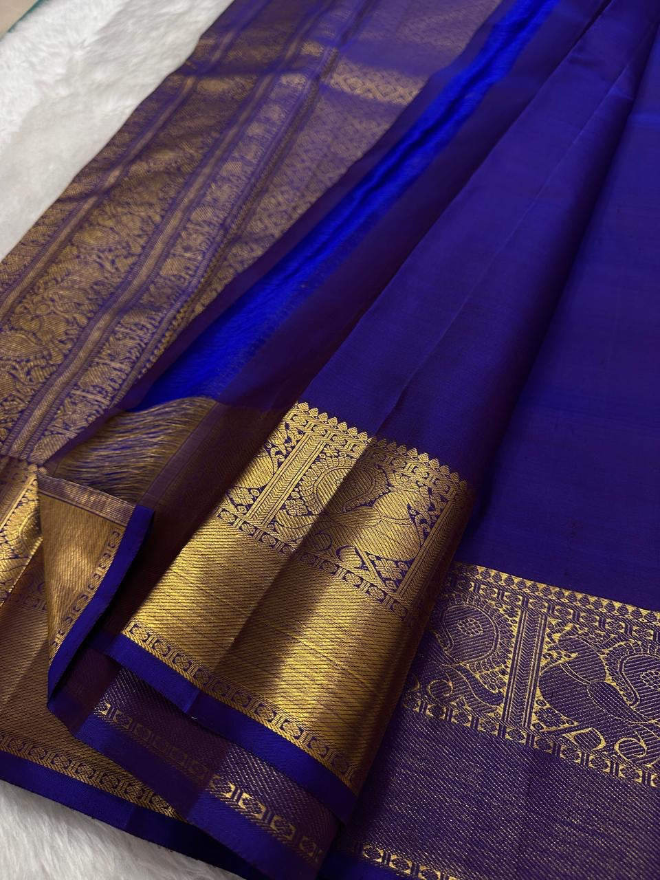 Neelam Blue Kanchipuram silk saree showing large reinterpreted maanga motifs spaced with smaller baby zari buttas across the Neelam blue body.