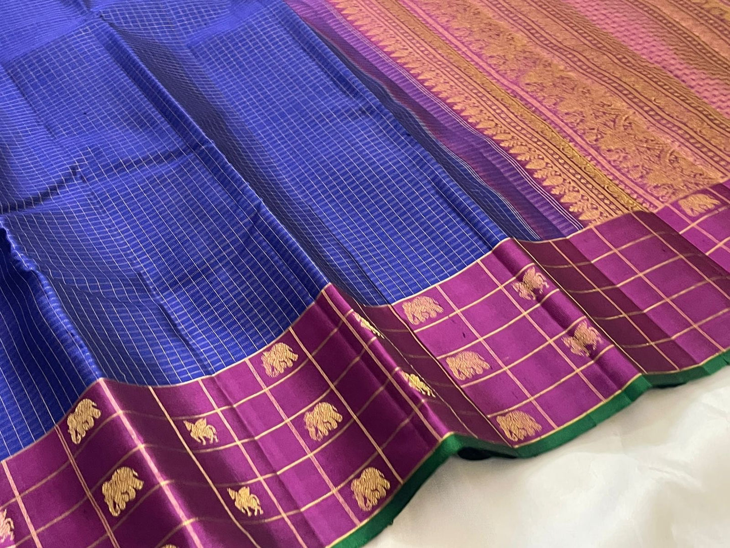 Deep magenta vanasringaram border with elephant and horse butta in gold zari on royal blue Kanchipuram saree — Idam Living