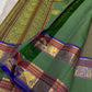 Moss Green Shot Silk pure silk Kanchipuram saree, border detail, showing muted olive-moss and sage green shot with golden undertones, brighter emerald pallu, deep cobalt-blue silk-thread accents, copper-rust bands and antique-gold zari